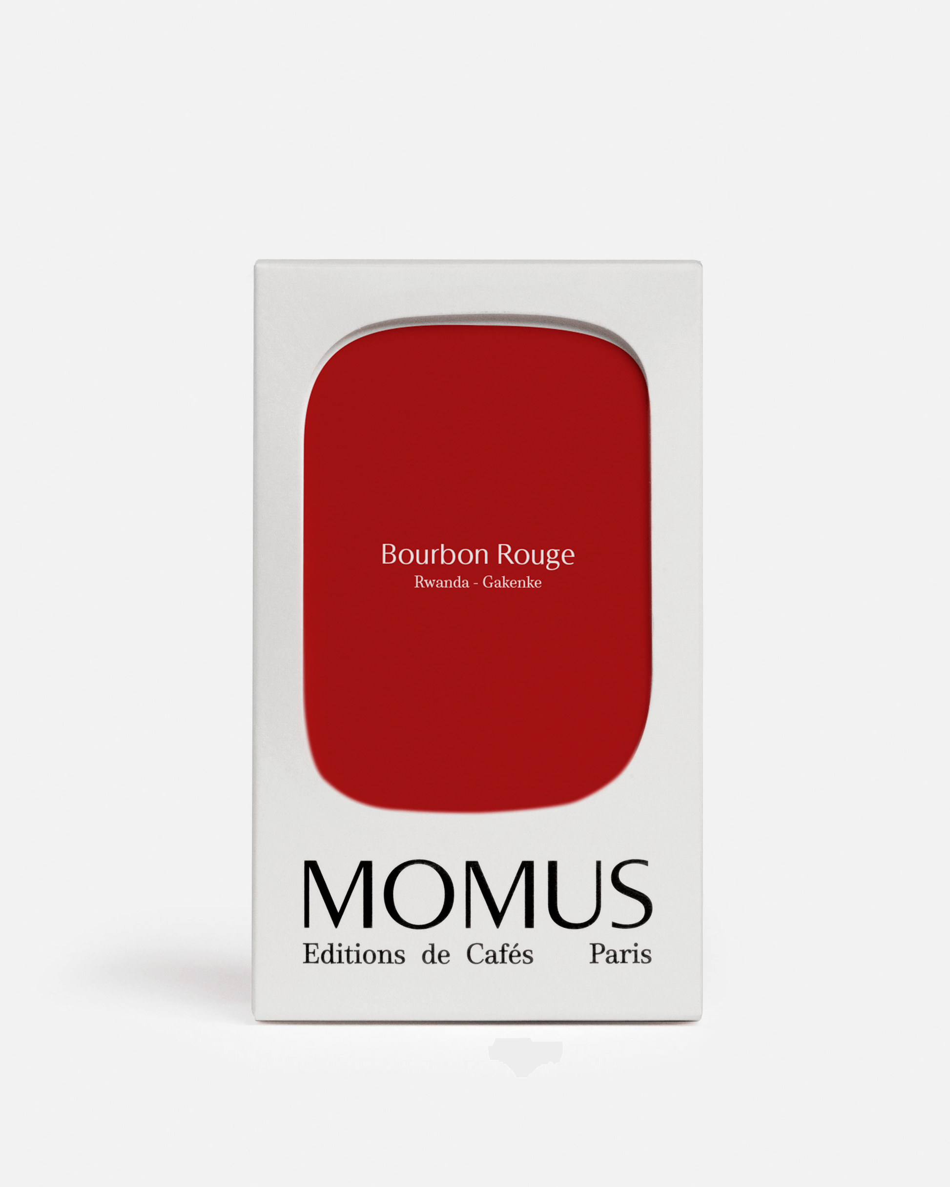 Boîte blanche de café Momus, Éditions de Cafés Paris, avec un encadré rouge vif au centre portant l'inscription "Bourbon Rouge Rwanda - Gakenke".