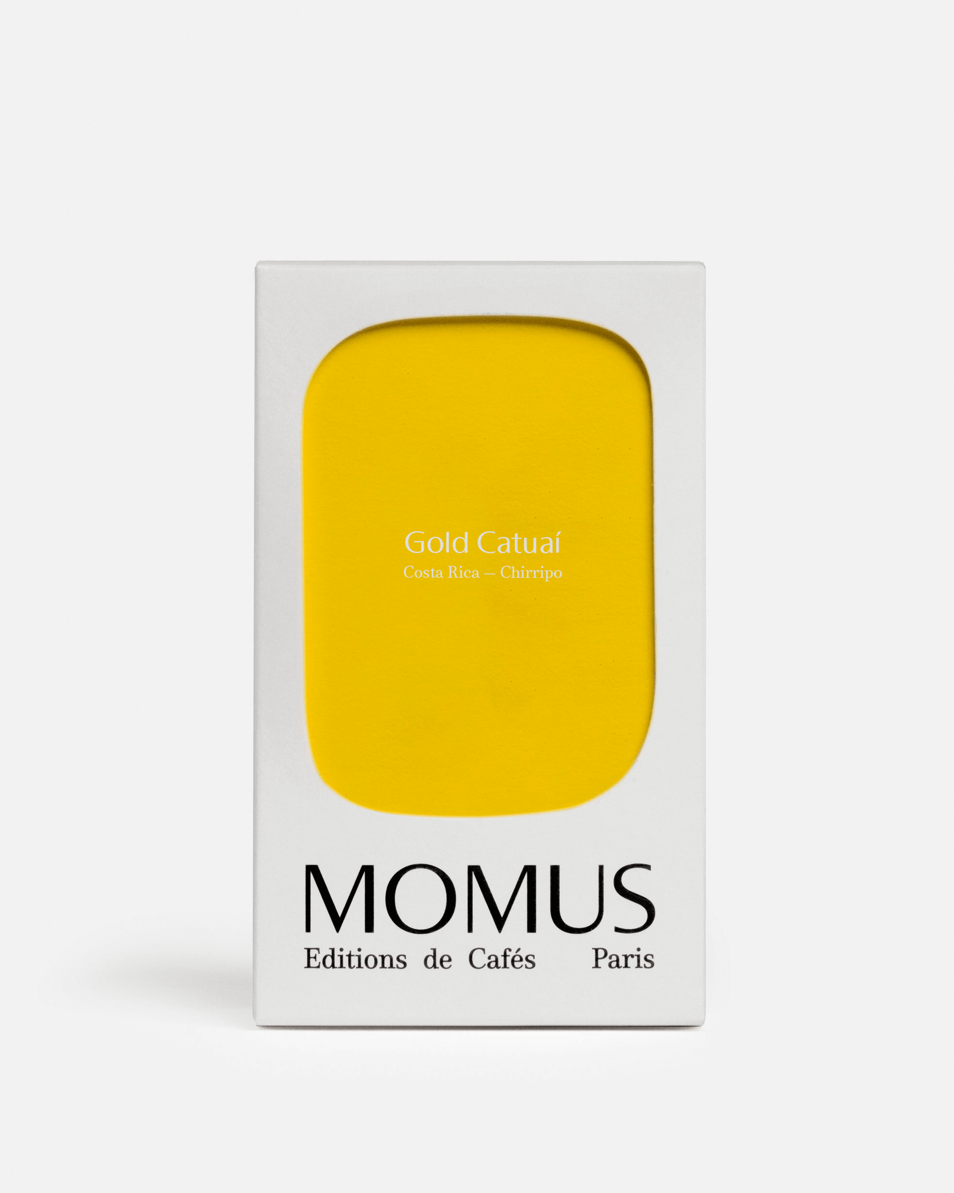 Packaging du café Gold Catuaí de Momus, éditions de cafés, avec façade jaune minimaliste.