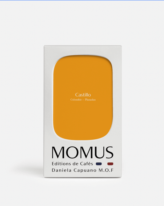 Emballage de café Castillo de la marque MOMUS, avec une étiquette jaune, mettant en avant la provenance colombienne.