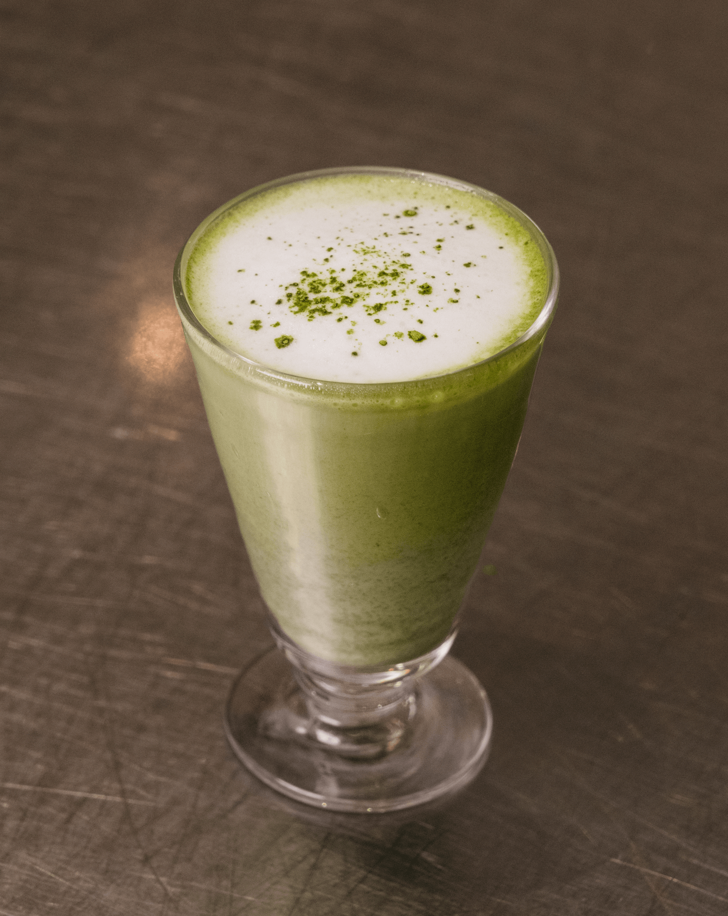 Verre de matcha avec mousse saupoudrée 
